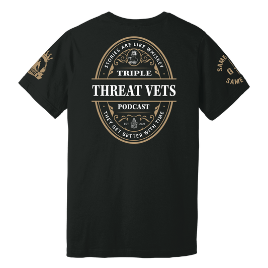 A black T-shirt with a vintage-style oval graphic design featuring text related to the Triple Threat Vets podcast. The T-shirt has 'Triple Threat Vets' and a quote about stories getting better with time as central elements.
